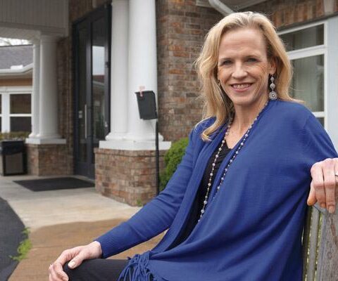 Kelly Marschewski Lasseigne sits in front of the 20th Century Club Lodge in Little Rock where she volunteers serving meals to cancer patients. She began volunteering after receiving treatment for alcoholism.