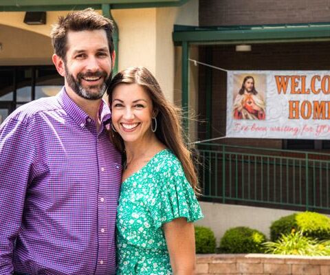 Seth and Amber Haines smile June 22 in front of their new faith home, St. Joseph Church in Fayetteville. They joined the church May 17, after being delayed since Easter in becoming Catholic along with their four sons.