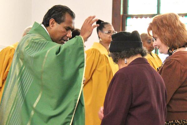 Father Siprianus Ola Rotok, SVD, blesses congregants at St. Peter Church in Pine Bluff. Originally from Indonesia, he has served in Bolivia, Texas, Iowa, Louisiana and Arkansas throughout his 25 years of ministry.