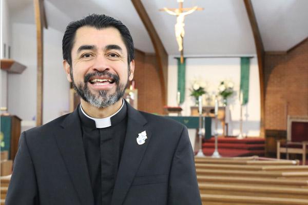 Deacon Daniel Velasco pauses a moment July 23 in the sanctuary of St. John Church in Russellville, where he has served as a deacon since May. He is a native of Puebla, Mexico.