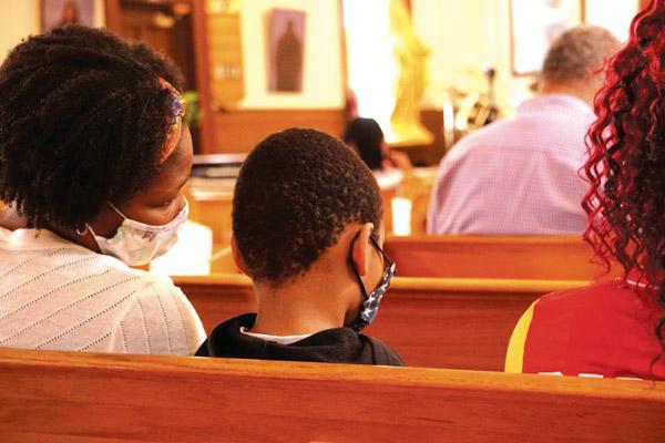 Emily Issioffia and her son Isaac pray during Mass Aug. 30 at St. Bartholomew Church in Little Rock. Families like the Issioffias will benefit from a new Parish Life Center where religious education classes and parish programs can be held, with a one-year boost from One Church support.