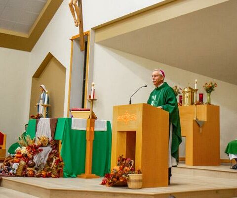 Bishop Anthony B. Taylor blesses the newly renovated sanctuary of St. John Newman University Parish in Jonesboro Nov. 15. The sanctuary received several updates including new flooring and donated statues and crucifix.