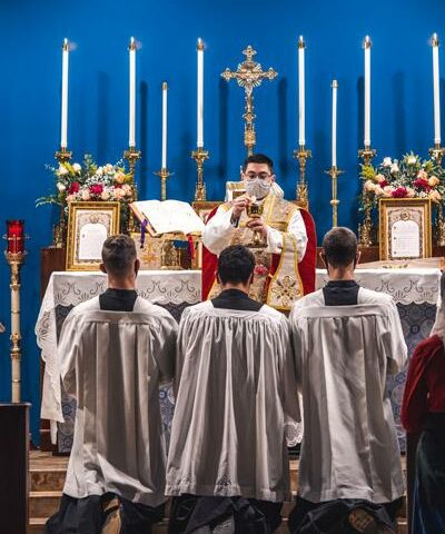 Father Joshua Passo, FSSP, elevates the Eucharist during the Dec. 12 Mass dedicating Our Lady of Sorrows as a new parish for the Diocese of Little Rock in Springdale.
