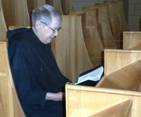 Father Jerome Kodell, OSB, reads while praying in St. Benedict Church at Subiaco Abbey Feb. 18. The priest and former abbot said even two minutes of silence each day can be fulfilling prayer time.