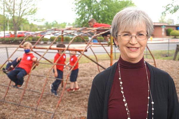 Principal Vivian Fox smiles as students of St. John School in Russellville play on the playground April 14. In an effort to boost Latino enrollment and understand the culture, Fox and three other principals will attend the Latino Enrollment Institute this summer.
