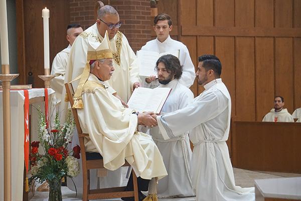 Jaime Nieto makes his promise of the elect, including respect and obedience to Bishop Anthony B. Taylor during his diaconate ordination at St. Raphael Church in Springdale May 21. Nieto, 31, will be ordained to the priesthood next year.