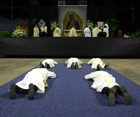 The five men seeking ordination lay prostrate on the floor of Barton Coliseum as a sign of surrender before God while the congregation sings the Litany of Saints.