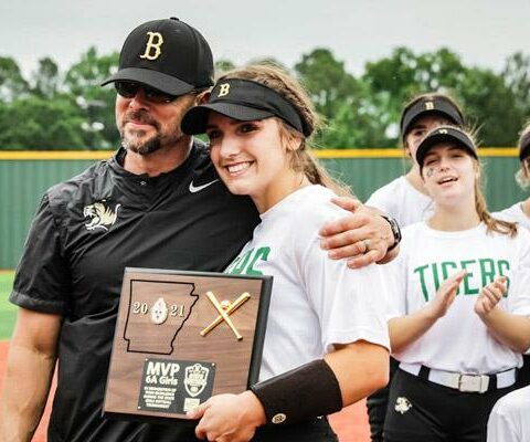 Emily Perry receives the Most Valuable Player Award following the state tournament game in Benton  May 21. Perry, with Bentonville High School Head Softball Coach Kent Early, and the Lady Tigers won their fourth state title in the past six years and went 29-3 this season.