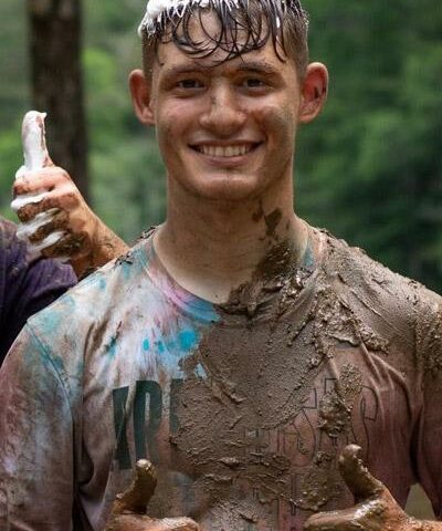 Ethan Harris gives a muddy thumbs-up at Camp Covercrest in July.