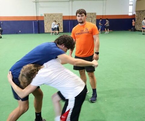 As they prepare for their first year of competition, head wrestling coach Andrew Cannon helps wrestlers with their technique during practice Nov. 16 at Subiaco Academy.