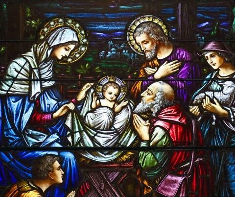 This stained-glass window at St. Aloysius Church in Great Neck, N.Y., depicts Jesus in a manger surrounded by Mary, Joseph and three shepherds. The feast of the Nativity of Christ, a holy day of obligation, is celebrated Dec. 25.