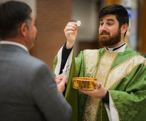 Father Jon Miskin distributes Communion Jan. 25 at St. Raphael Church in Springdale. The Eucharist is one aspect of the faith Catholics can study and pray about during Lent.