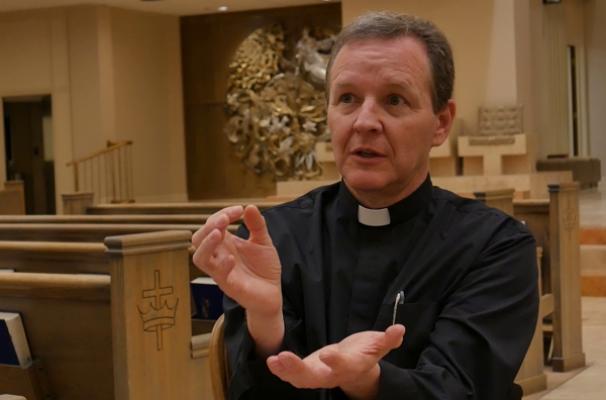Father Erik Pohlmeier, pastor of Christ the King Church in Little Rock, displays how to receive Communion reverently for a video on the real presence of Christ in the Eucharist, Feb. 9.