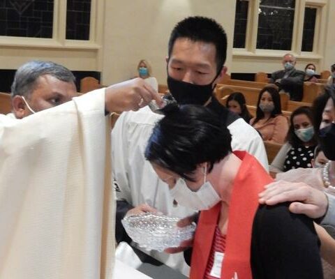 Jennifer Nobles is baptized by Father Ravi Rayappa Gudipalli during the 2021 Easter Vigil Mass at St. Mary of the Springs Church in Hot Springs.