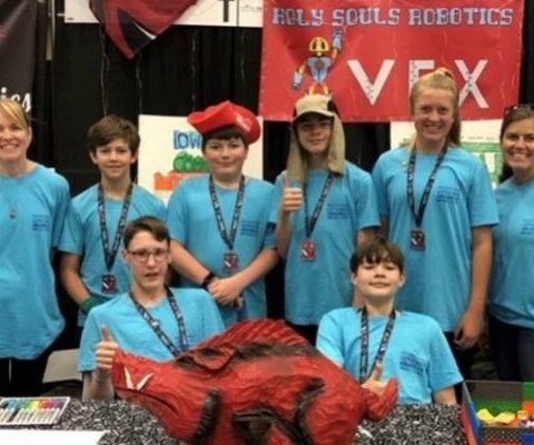 Holy Souls Robotics Team members and chaperones (front row, left to right) George Saer, Curan Zachritz, (back row, left to right) parent Amanda Brooks, Peyton Baker, Dean Doose, Harrison Brooks, Carson Vogelpohl and robotics team coach Jill Wingfield at the VEX Robotics World Championship in Dallas, May 3-5. The competition featured 688 teams from 49 states, three Native American nations and 27 countries.