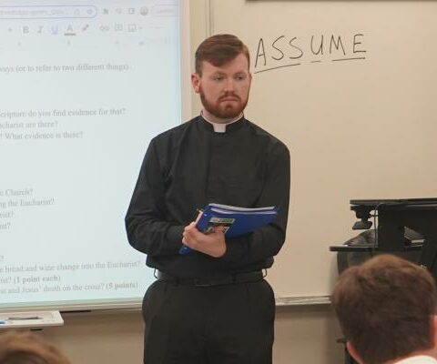 Seminarian Quinton Thomas, 22, prepares students to prayerfully meditate at the start of his religion class at Catholic High School in Little Rock May 13. Thomas said his call to celibacy frees him to pour his entire self into various ministries, including teaching.