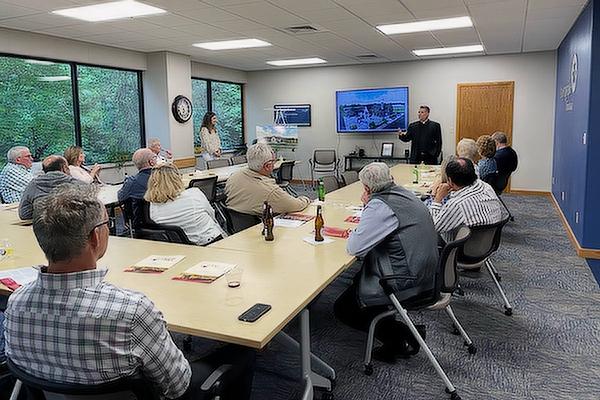 Father Jason Sharbaugh, pastor of St. Thomas Aquinas University Parish in Fayetteville, addresses a capital campaign event hosted by Kenneth and Sharon Siebenmorgen in Fort Smith May 26.