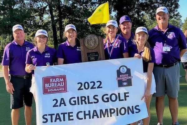 St. Joseph Lady Bulldogs show off the 2A state championship hardware. They are assistant coach Brent Breeding (left), Avery White, Kaitlyn Kordsmeier, Presli Webb, assistant coach Lindell Atkinson, Allie Evans and head coach Mike Prall.