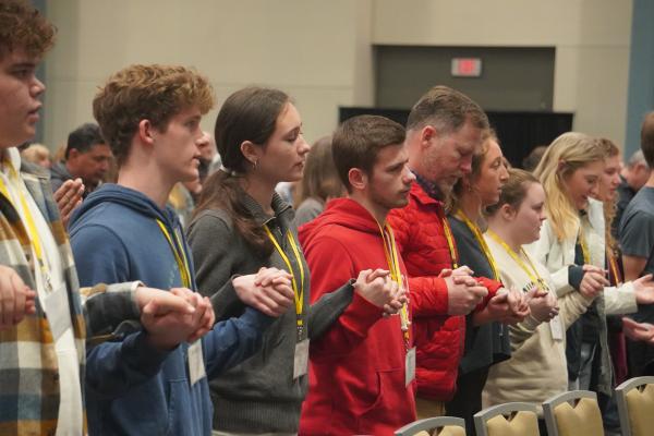 Members of the youth group at St. Agnes Church in Mena and their chaperones join hands to pray the Lord&#039;s Prayer during the annual Mass for Life in the Wally Allen Ballroom at the Statehouse Convention Center in Little Rock Jan. 22. (Malea Hargett photo)  