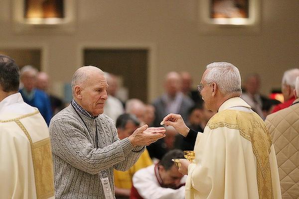 Deacon Richard Papini of St. Joseph Church in Conway receives the Eucharist from Bishop Anthony B. Taylor at the 13th annual Arkansas Catholic Men&#039;s Conference at Christ the King Church in Little Rock on &ldquo;Super Bowl Saturday,&rdquo; Feb. 11. (Chris Price photo)
