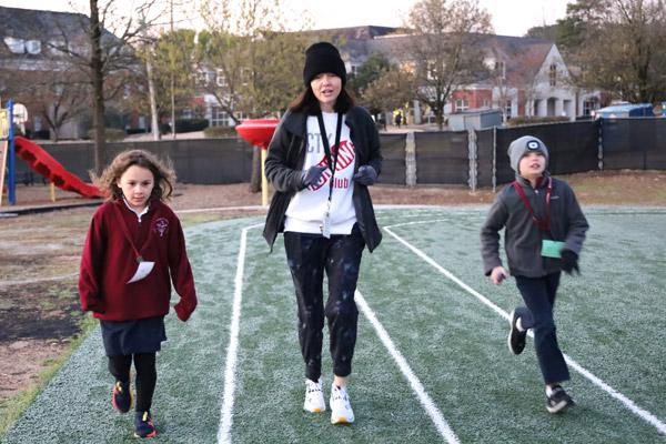 P.E. teacher Courtney Cancienne formed the Christ the King School Running Club this school year for third- and fourth-graders. Runners, seen here March 15, meet weekly for one hour.