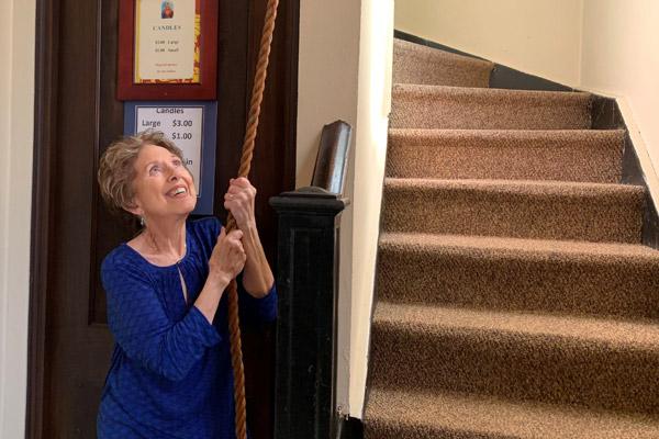 Joanne Rosenau, parishioner of St. Mary of the Springs Church in Hot Springs, pulls the rope to ring the church's century-old bell before the 4 p.m. Mass April 1.