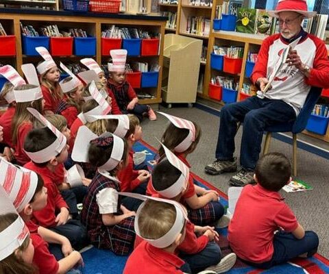 Mayor Lioneld Jordan of Fayetteville reads to first- grade students in honor of Read Across America week at St. Joseph School March 3. As new tuition vouchers are phased in, Catholic schools must figure out how many new students they can accept and how to serve their needs.