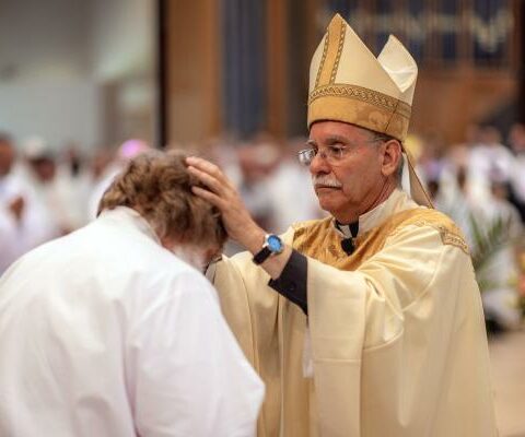Bishop Anthony B. Taylor ordains Deacon Tom Parks of Rogers during an ordination Mass June 25, 2022, at St. Vincent de Paul Church in Rogers.