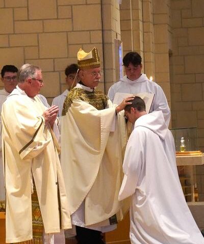 Bishop Anthony B. Taylor ordains Brother Raban Heyer to the transitional diaconate July 15 in the Subiaco Abbey church. Brother Raban will return to Rome this fall to finish his final year of studies before being ordained a priest.