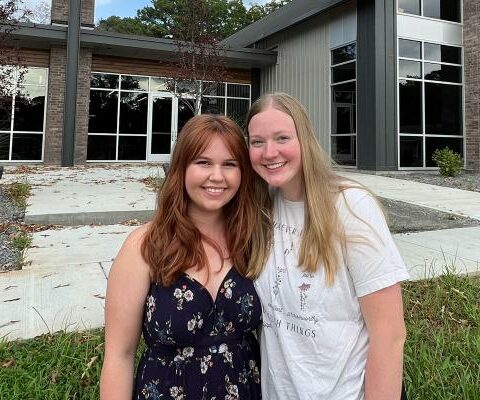 University of Central Arkansas students Sarah Duvall of Morrilton (left) and Gracie Weidman of Fort Smith smile Aug. 10 at the new Catholic Campus Ministry building in Conway. The pair are co-directors of the CCM music ministry.