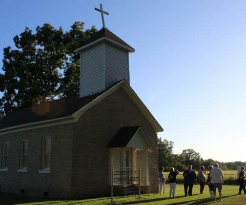 Catholics around Jefferson County catch up following monthly Mass Aug. 31 outside St. Mary Church in Plum Bayou, the oldest Catholic church in Arkansas.