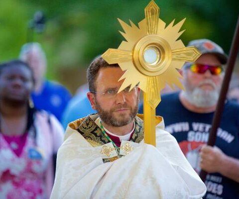 Auxiliary Bishop Andrew H. Cozzens of St. Paul and Minneapolis carries the Eucharist in a monstrance during a procession June 19, 2021.