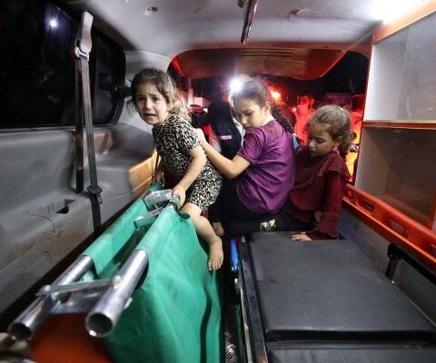 Children sit in the back of an ambulance at Shifa Hospital following an airstrike on the CNEWA-supported al-Ahli
Arab Hospital in Gaza City Oct. 17.