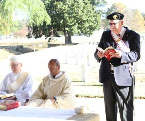 Knight of Columbus member Alan Carlson (right) lectors during the Veterans Day Mass Nov. 11 at the Little Rock National Cemetery, celebrated by Father Bhaskar Malapolu. Deacon Jim Goodhart (left) assisted.