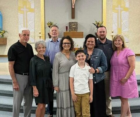 Kate Davis (third from right), the director of finance at Mount St. Mary Academy in Little Rock, stands with family and friends after being received into the Church in June. Her sponsor, Kelly Wewers (far right), also works in financial aid at Mount St. Mary.