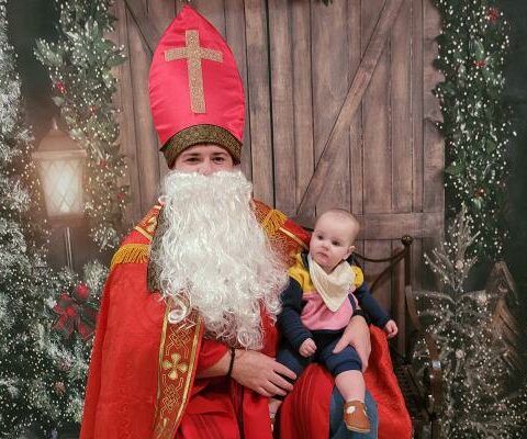 Zach Gramlich dressed as St. Nicholas poses with his daughter Bonnie Gramlich at Christkindl Market at St. Boniface Church in Fort Smith Dec. 2.