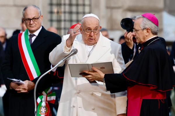 Pope Francis gives his blessing after in front of a Marian statue near the Spanish Steps in Rome Dec. 8, 2023, the feast of the Immaculate Conception. Roberto Gualtieri, the mayor of Rome, is at the left.