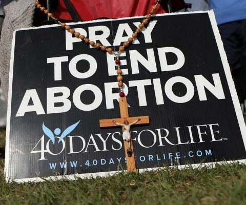 Pro-life activists pray with rosaries as clients arrive at the Bread and Roses Woman's Health Center, a clinic that provides abortions in Clearwater, Fla., Feb. 11, 2023.