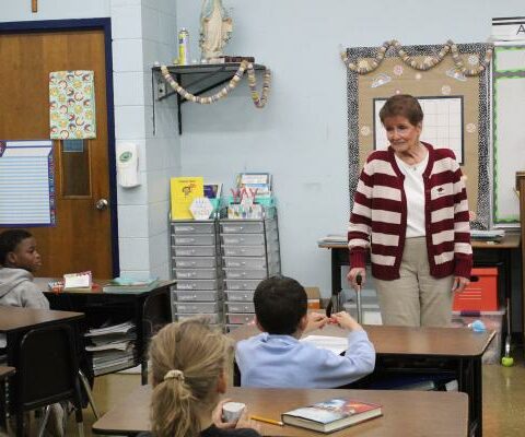 Denise Troutman, principal of North Little Rock Catholic Academy, talks with second graders before school Mass April 4. After 30 years, Troutman will retire in May but plans to stay close by. (Katie Zakrzewski)