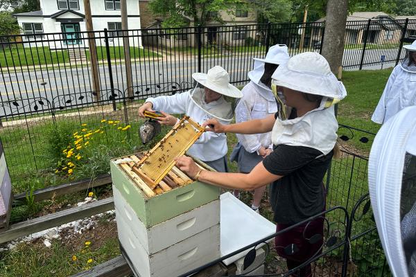 Members of the Honey Belles beekeeping club at Mount St. Mary Academy in Little Rock extract honey from the beehives in October 2023. (Maureen Stover)