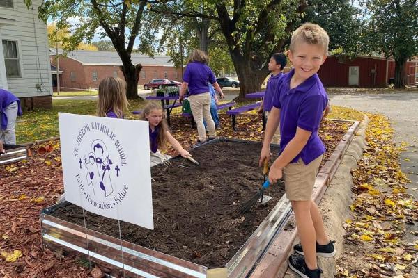 Students at St. Joseph School in Paris work in the butterfly garden May 2024. (Courtesy Michelle O&#039;Neal)