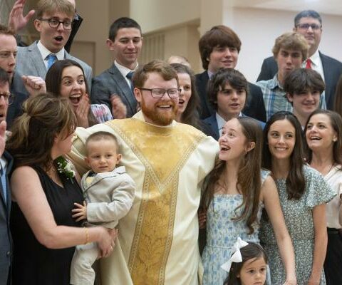 Father Cody Eveld celebrates with his family and friends after being ordained at Christ the King Church in Little Rock May 25. (Bob Ocken)