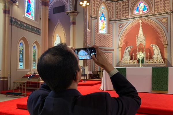 Andrew Masi takes photos of the Cathedral of St. Andrew in Little Rock June 9. Masi is on a pilgrimage to photograph every cathedral and basilica in the U.S. (Katie Zakrzewski)